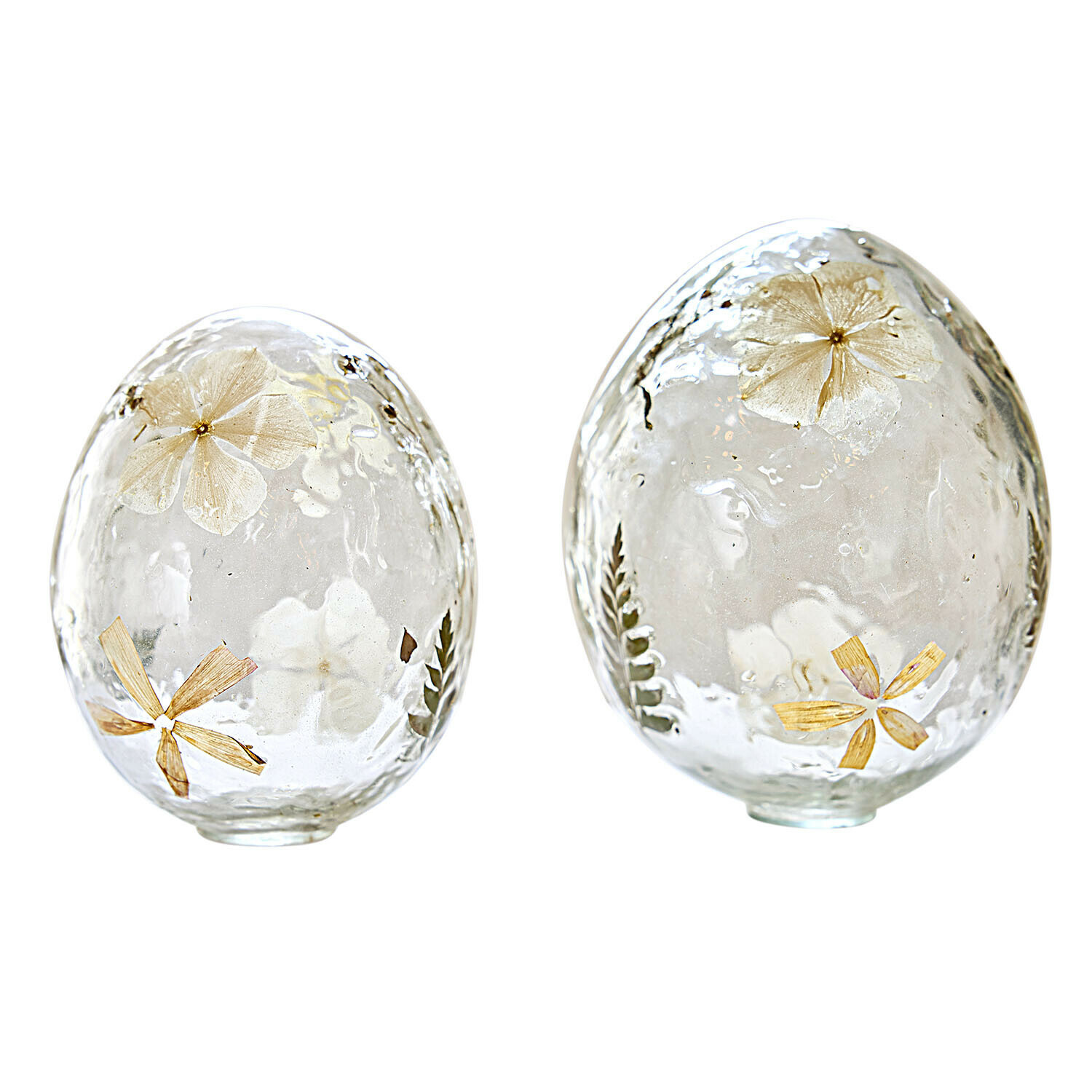 Dvě průhledná skleněná vejce s vloženými sušenými květy a listy, jarní dekorace